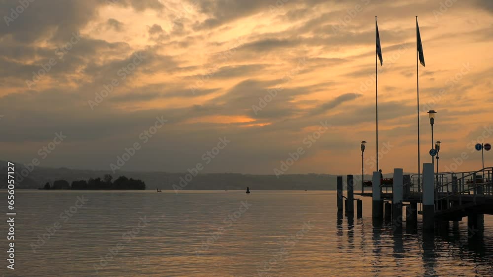sunset on Lake Zurich, pier on the lake in the rays of the evening sun sunset on Lake Zurich, pier on the lake in the rays of the evening sun