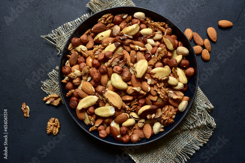 Assortment of nuts in black bowl. Top view with copy space.