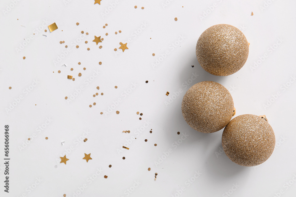 Christmas balls and confetti on white background