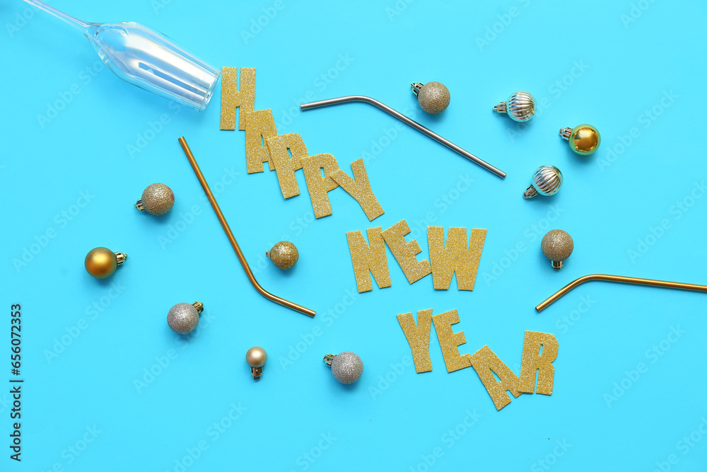 Text HAPPY NEW YEAR with Christmas balls and straws on blue background