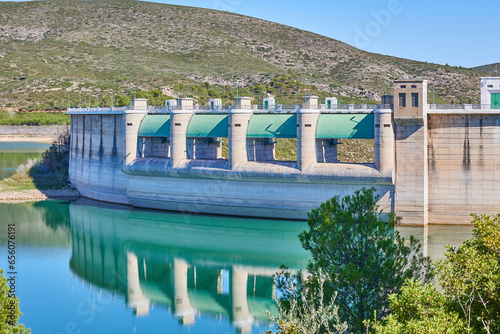 View of the dam gates at low water levels in the reservoir after a long drought. Forata reservoir, Valencia, Spain. photo