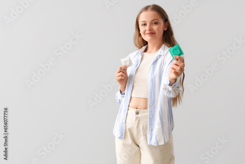 Young woman with condoms on...
