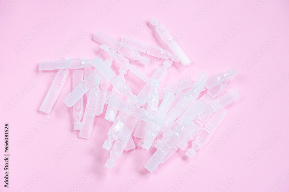 Medical eye drops in plastic pipettes. Plastic vials of saline solution