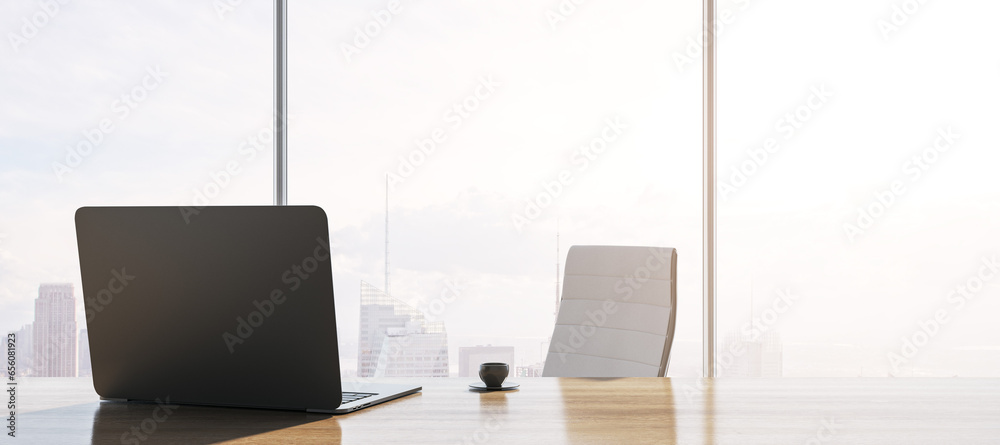 Fototapeta premium Close up of contemporary backlit wooden desk with laptop, table lamp, coffee cup and panoramic window with city view in the background. 3D Rendering.