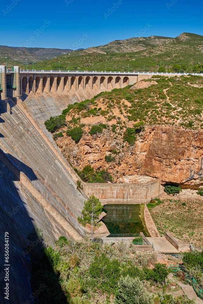View of the dry spillway of a concrete dam during a long drought. Forata reservoir, Valencia, Spain.
