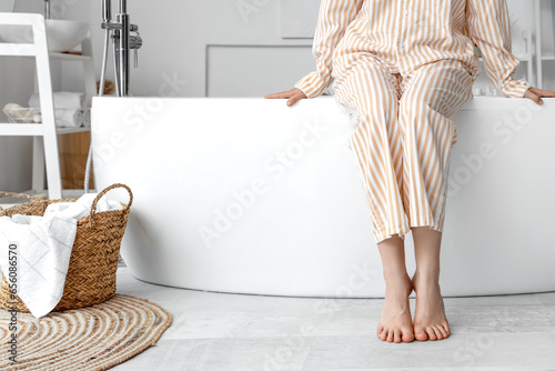 Barefoot woman in bathroom ...