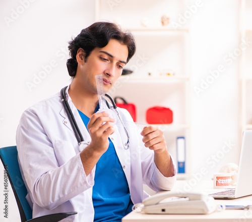 Young male doctor with goniometer photo