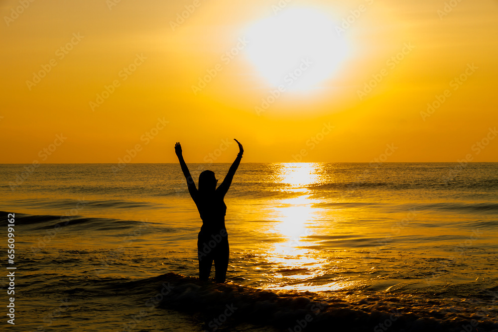 Fototapeta premium Woman body big with bikini and sunrise on beach