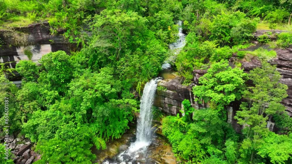 Aerial view of lush tropical forest with cascading waterfall, nature's hidden masterpiece. Soi Sawan Waterfall, Pha Taem National Park, Ubon Ratchathani Province, Thailand. Waterfall background.
Aerial view of lush tropical forest with cascading waterfall, nature's hidden masterpiece. Soi Sawan Waterfall, Pha Taem National Park, Ubon Ratchathani Province, Thailand. Waterfall background.