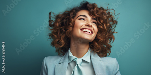 happy, smiling young woman, against a blue background