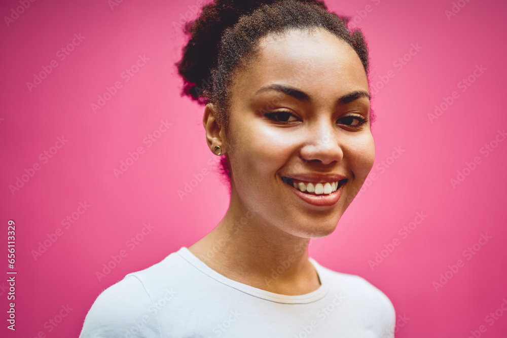 Close up portrait of cheerful dark skinned hipster girl dressed in t-shirt with copy space Close up portrait of cheerful dark skinned hipster girl dressed in t-shirt with copy space
