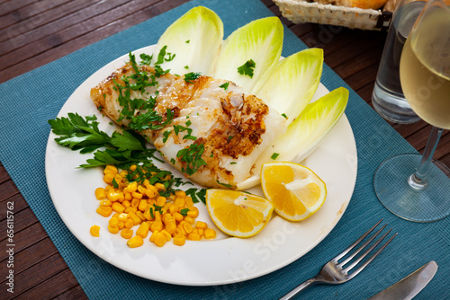 Canvas Print Delicate baked pink cusk-eel fillet with side dish of fresh endive leaves, pickl