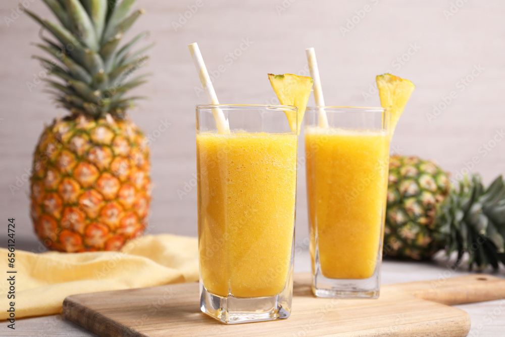 Tasty pineapple smoothie and fresh fruits on table Tasty pineapple smoothie and fresh fruits on table