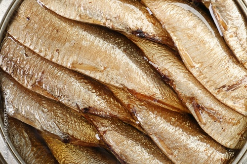 Canned sprats in oil as background, top view