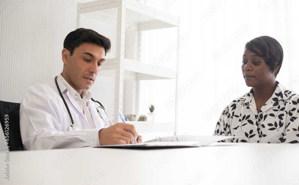 Hispanic physician check-up African American patient with stethoscope at the hospital. Healthcare medical diagnosis and examining. Hispanic physician check-up African American patient with stethoscope at the hospital. Healthcare medical diagnosis and examining.