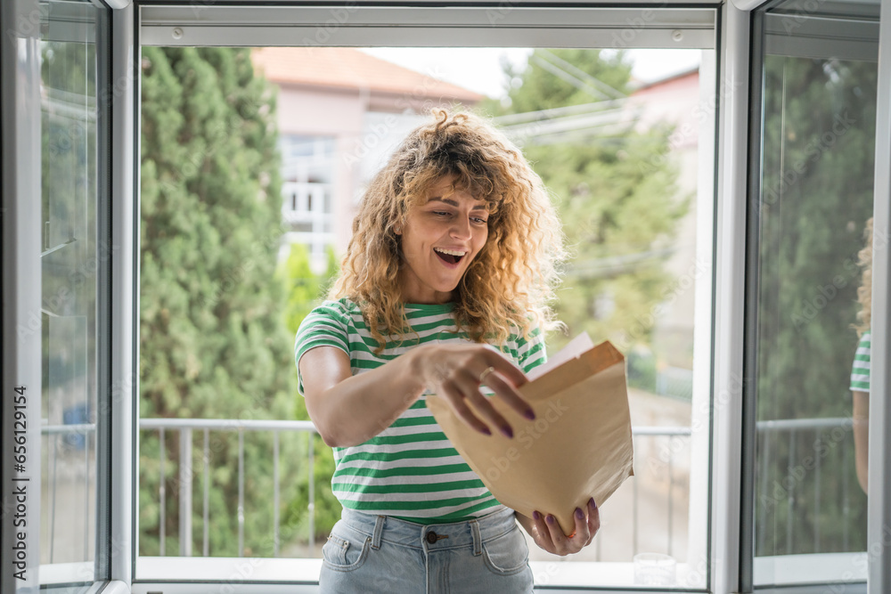 caucasian woman open mail letter or document envelope at home caucasian woman open mail letter or document envelope at home