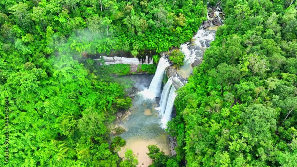 Behold a grand, awe-inspiring waterfall, commanding attention in the heart of a pristine, dense, tropical wilderness. Nature's regal spectacle. Phu Chong Na Yoi national park, Thailand. Drone view.
Behold a grand, awe-inspiring waterfall, commanding attention in the heart of a pristine, dense, tropical wilderness. Nature's regal spectacle. Phu Chong Na Yoi national park, Thailand. Drone view.