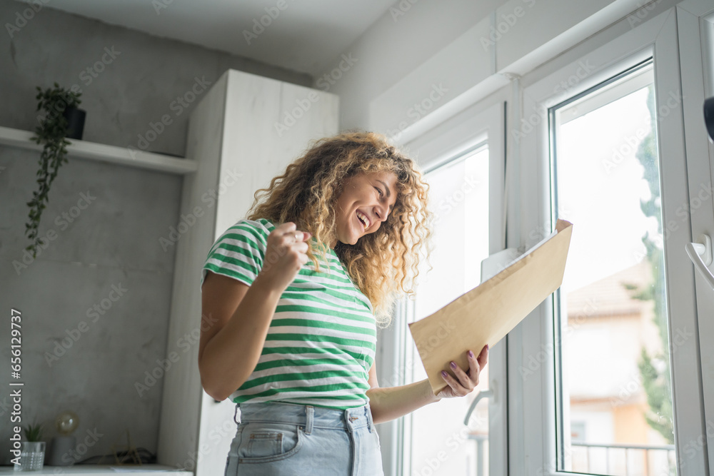 caucasian woman open mail letter or document envelope at home caucasian woman open mail letter or document envelope at home