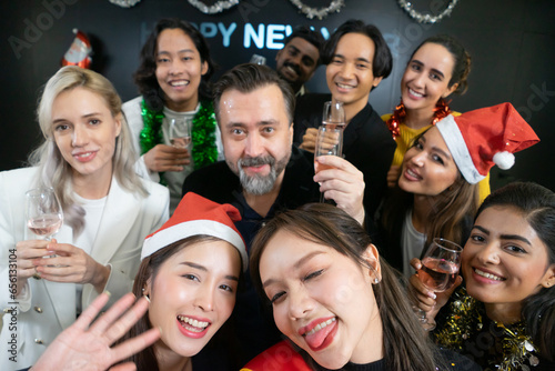 Let's take a selfie !! A group of diverse business people and colleagues having fun together at a business New Year party. A teamwork celebration of a successful.