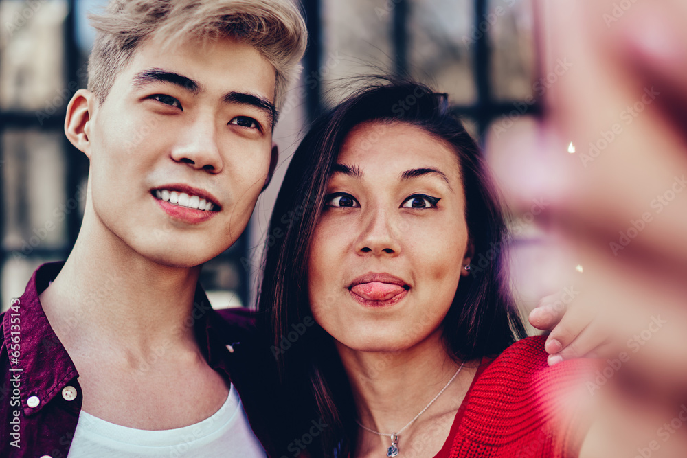 Positive asian couple in love standing outdoors and spending time together Positive asian couple in love standing outdoors and spending time together