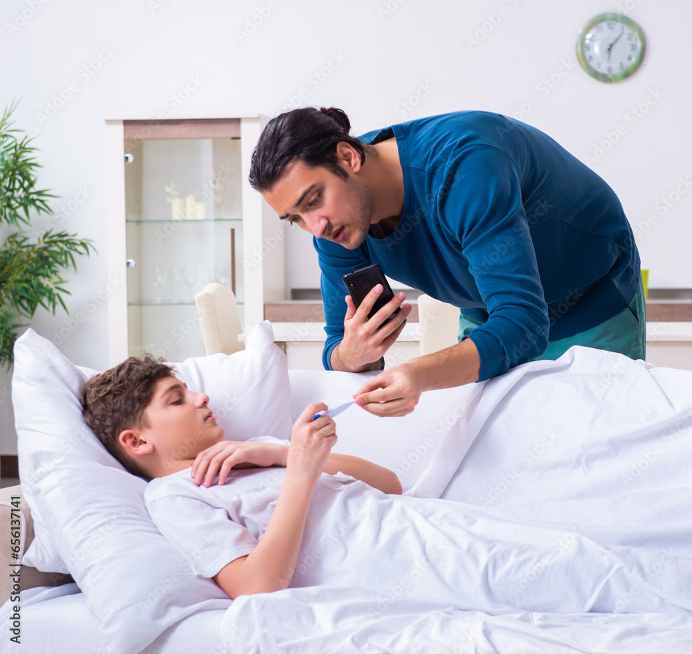 Obraz premium Young father caring for sick son