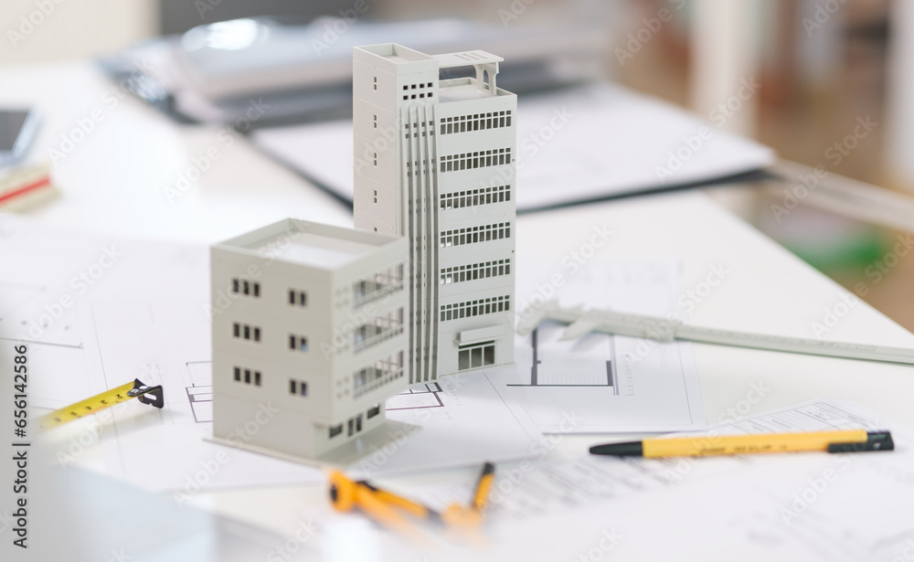 Architectural model on desk with laptop, drawing technical tools and blueprints. Architecture, building, construction and real estate business. - obrazy, fototapety, plakaty 