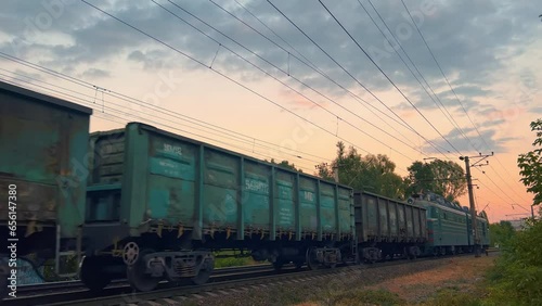 Freight train travels at sunset. Wide angle photo