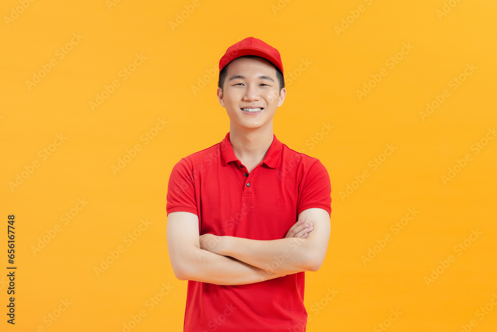 portrait of asian delivery man on yellow background