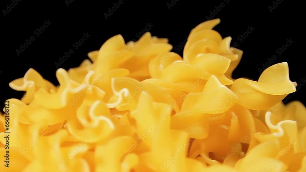 Uncooked Fusilli Pasta Heap Rotating against Black Background. Fat and Unhealthy Food. Dry Spiral Macaroni. Italian Culture and Cuisine. Raw Golden Pasta Uncooked Fusilli Pasta Heap Rotating against Black Background. Fat and Unhealthy Food. Dry Spiral Macaroni. Italian Culture and Cuisine. Raw Golden Pasta