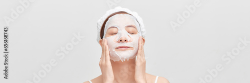 Woman apply face mask on banner background