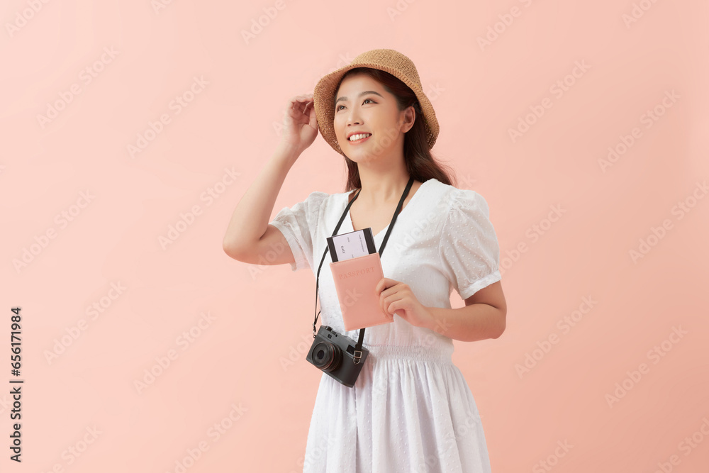 Beautiful travel woman with passport isolated on pink background