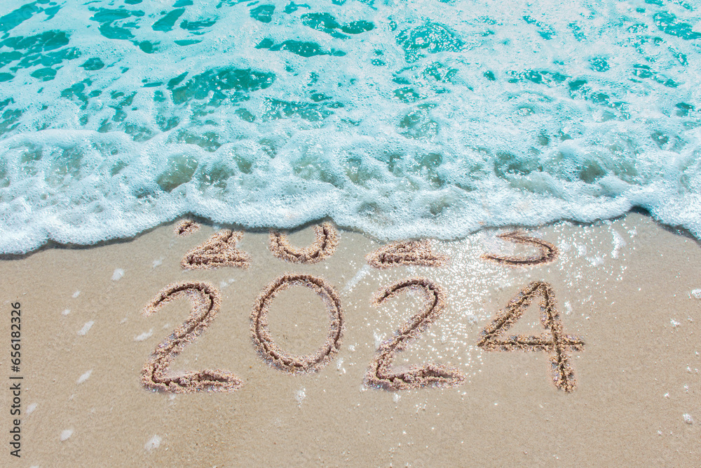 Message Year 2023 replaced by 2024 written on beach sand background. Good bye 2023 hello to 2024 happy New Year coming concept. - obrazy, fototapety, plakaty 