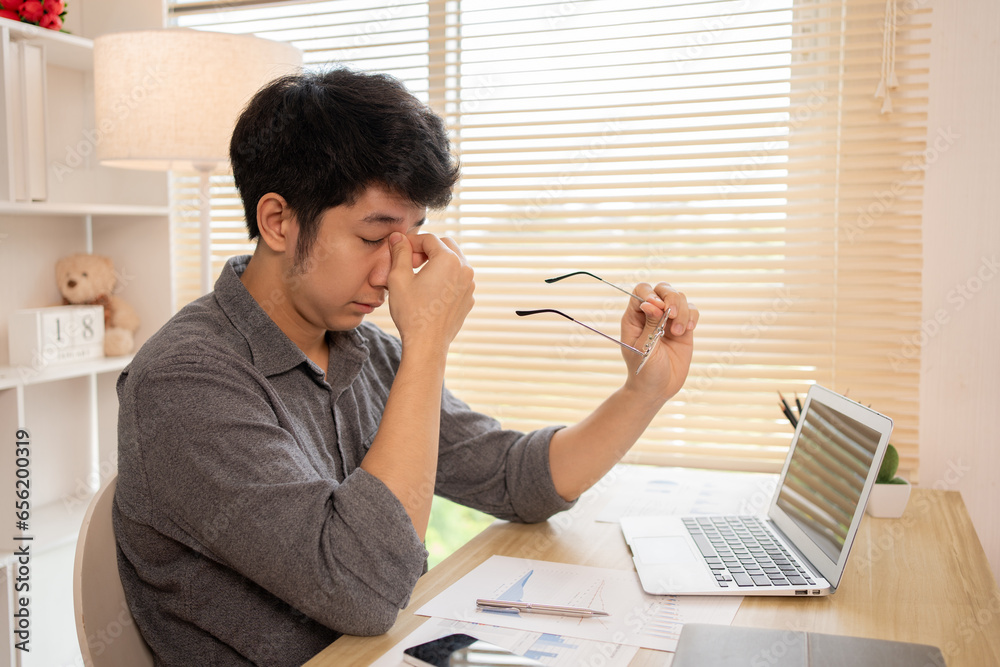 Tired Young Man Resting His Eyes from Prolonged Screen Time, Work