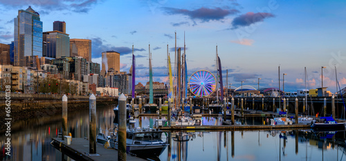 Seattle downtown waterfront buildings, the Great Wheel, and sail boats docked on Puget Sound at sunset Seattle, Washington, United States photo