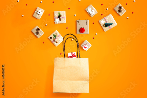 Christmas gift boxes with a shopping bag - overhead view flat lay