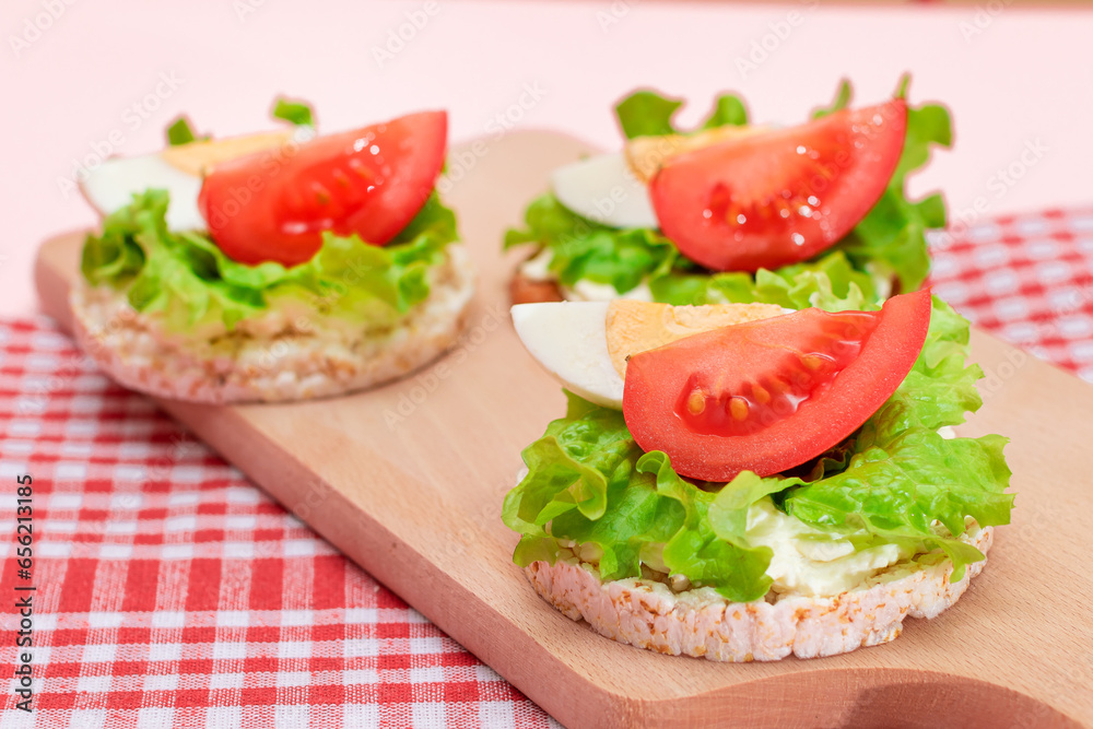 Rice Cake Sandwiches with Tomato, Lettuce and Egg on Wooden Cutting Board. Easy Breakfast. Diet Food. Quick and Healthy Sandwiches. Crispbread with Tasty Filling. Healthy Dietary Snack Rice Cake Sandwiches with Tomato, Lettuce and Egg on Wooden Cutting Board. Easy Breakfast. Diet Food. Quick and Healthy Sandwiches. Crispbread with Tasty Filling. Healthy Dietary Snack