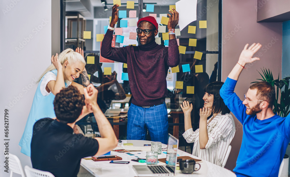 © BullRun - team building concept of congratulation female member of group with victory and great job