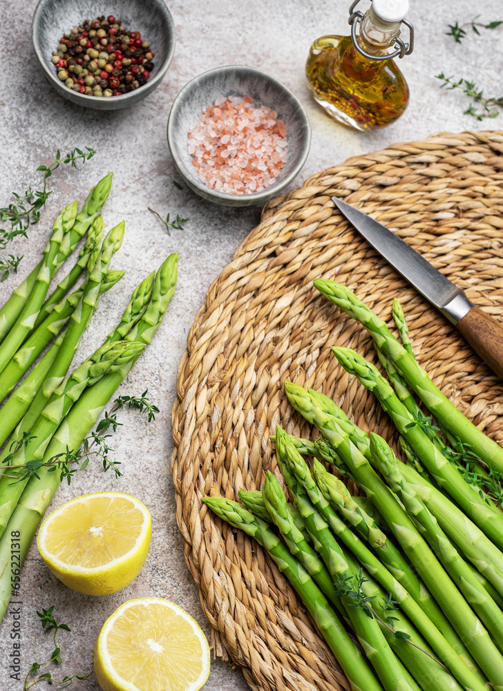 Bunch of raw asparagus stems with different spices