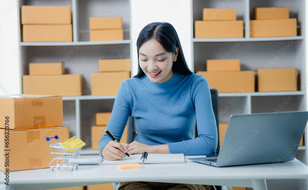 Start a small business Independent Asian woman holding a parcel box Young successful Asian woman with her packaging boxes, online marketing and shipping. Start a small business Independent Asian woman holding a parcel box Young successful Asian woman with her packaging boxes, online marketing and shipping.