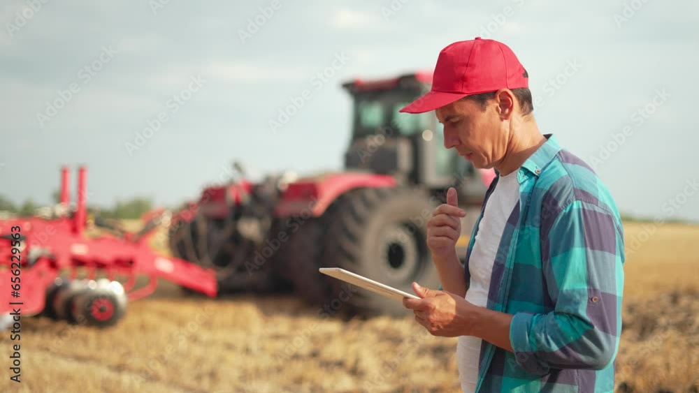 Work of an agronomist in field with tablet. use of technology in agriculture. Farmer agronomist controls work of tractor in harvesting field. Harvest technologies with tablet.Agriculture. Work of an agronomist in field with tablet. use of technology in agriculture. Farmer agronomist controls work of tractor in harvesting field. Harvest technologies with tablet.Agriculture.