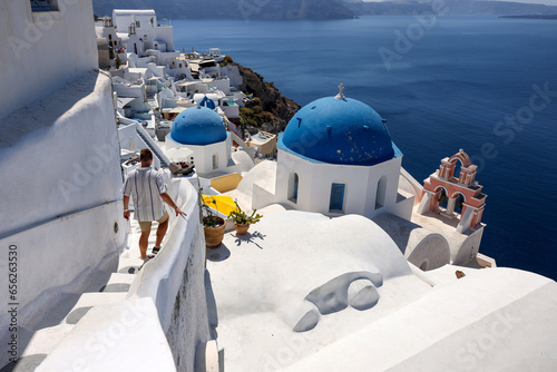  Whitewashed buildings on the edge of the caldera cliff in Oia village, Santorini, Greece