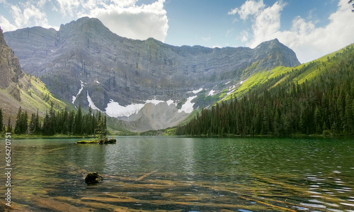 Rawson Lake clear water with submerged logs just beneath the surface with Mt Sarrail looming large in the background in Kananaskis Provincial Park Alberta, Canada photo