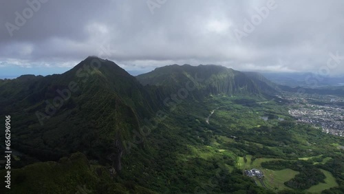 Nu‘uanu Pali -  overlooking cliff with city scape in the distance - flying backwards photo