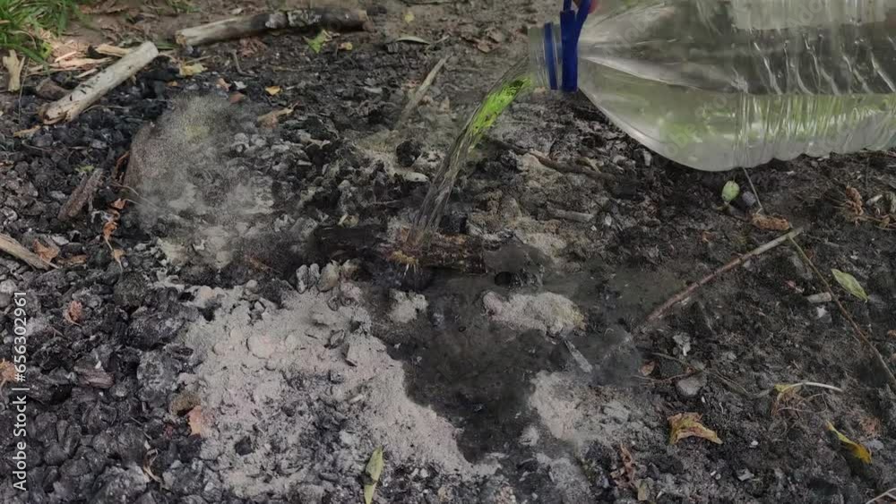 Man extinguished campfire before go away Man extinguished campfire before go away
