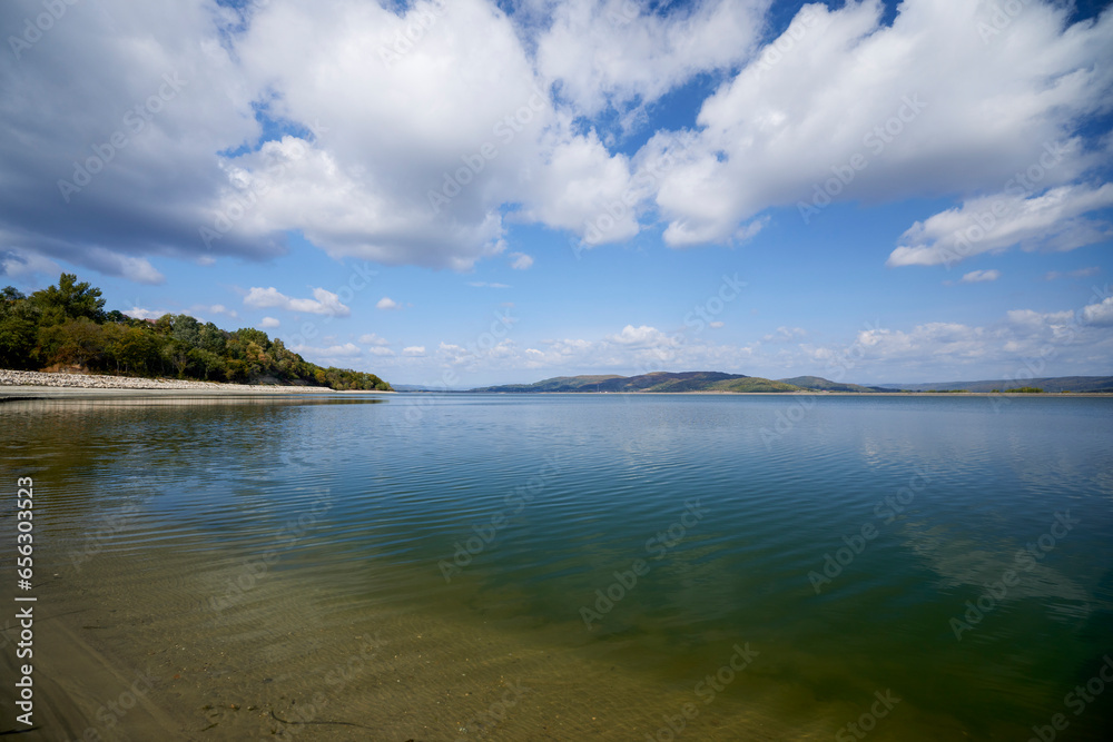beautiful landscape with clouds reflecting on a lake during the day beautiful landscape with clouds reflecting on a lake during the day