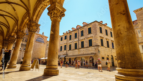 street view, crowds of tourists walking through the streets, medieval architecture, bright sunny day, travel, Old town Dubrovnik, Croatia