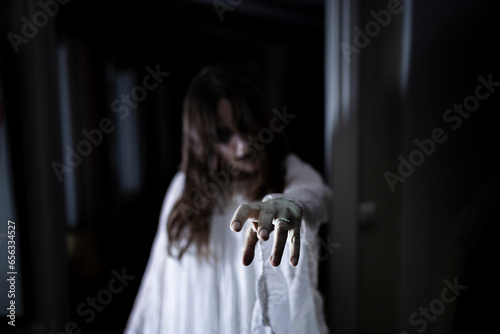 Spooky ghost reaching out at house