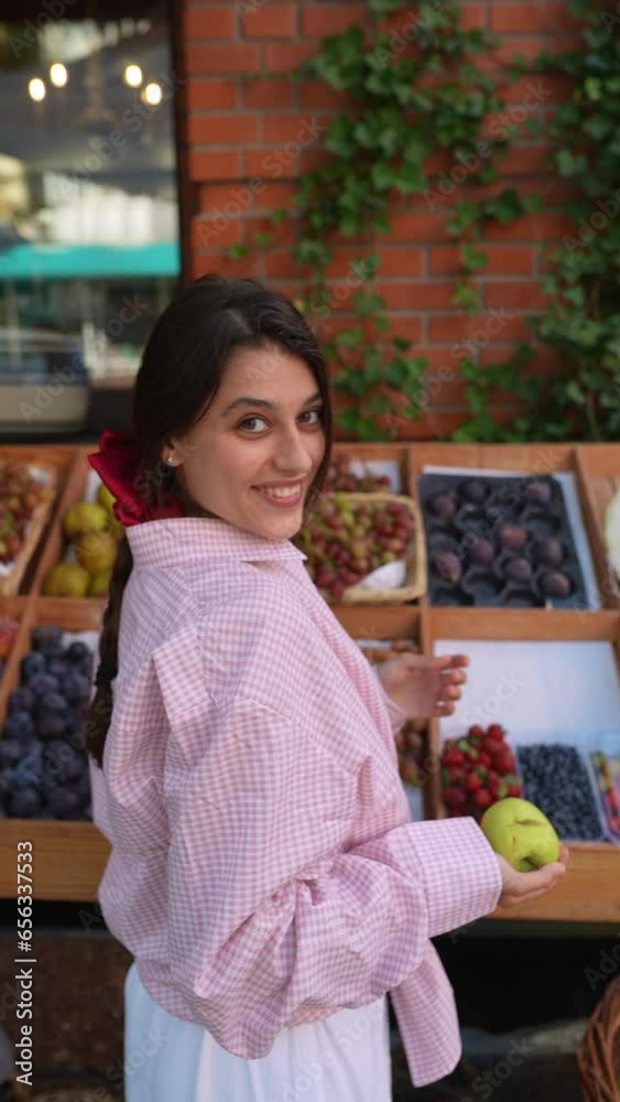 The farmer's market has a fashionable young woman vendor who is an expert on apple varieties. The farmer's market has a fashionable young woman vendor who is an expert on apple varieties.