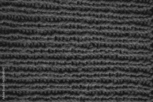 Handmade knitting material with macro weave threads.