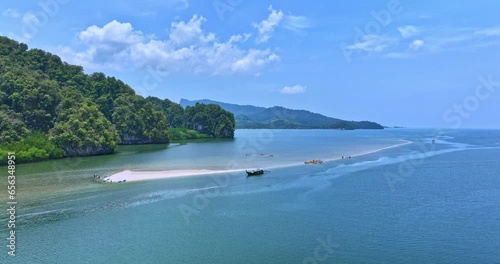 .Aerial view scenery white long sandbar stretch into the green sea. .tourists are relax on the white sandbar at Thalane Krabi Thailand. .Tourists Like to row a canoe in the mangrove forest. photo